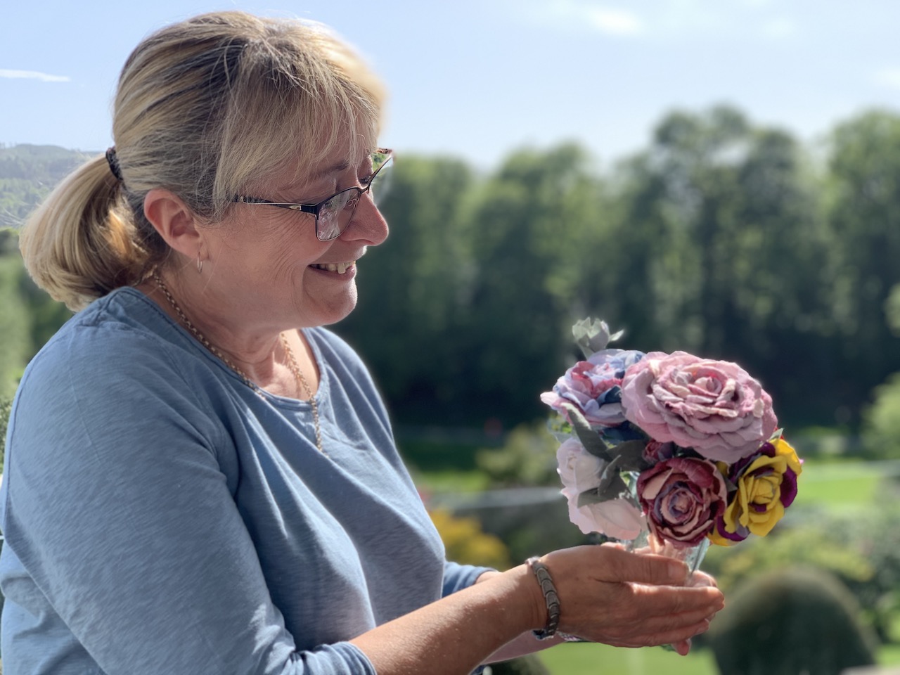 Brockhole creative expereince days - tutor Tracy Wells admires our roses from the Expereince Day workshop